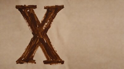 Brown Letter X on Parchment