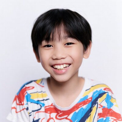 Asian boy smiling in colorful shirt