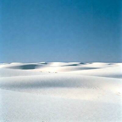 White sand dunes under blue sky