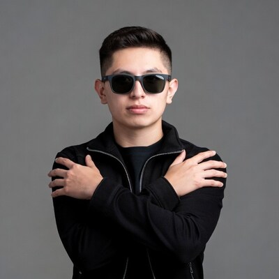 Asian young man in sunglasses arms crossed