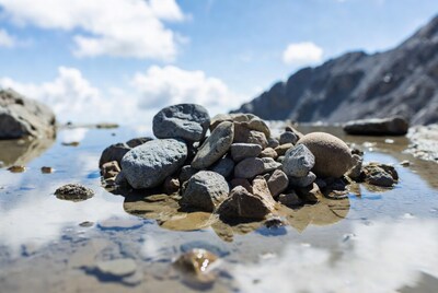 Pile of rocks in mountain puddle