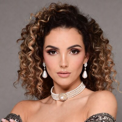 Woman with pearl necklace and earrings