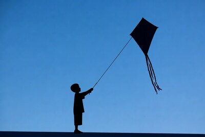 Boy flying kite silhouette