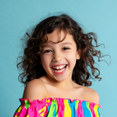 Smiling girl in colorful off-shoulder top