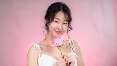 Asian woman holding pink rose