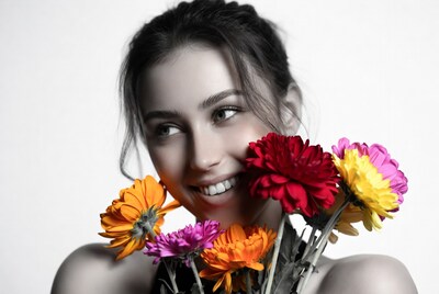 Woman smiling with colorful flowers