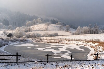 Frozen Pond in Snowy Winter Landscape