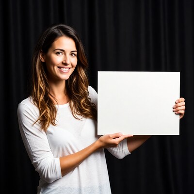 Smiling woman holding blank sign