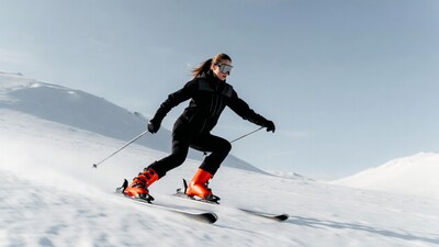 Woman skiing down snowy slope