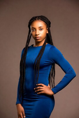 African woman in blue dress with braids