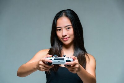 Asian woman holding game controller