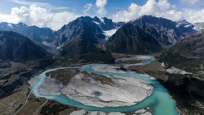 Turquoise River Meandering Through Snowy Mountains