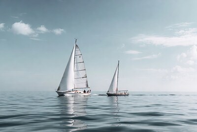 Two white sailboats on calm sea