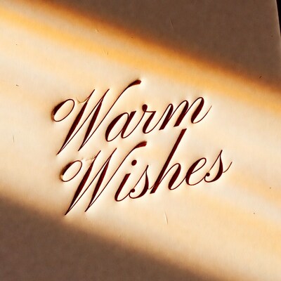 Warm Wishes embossed on paper