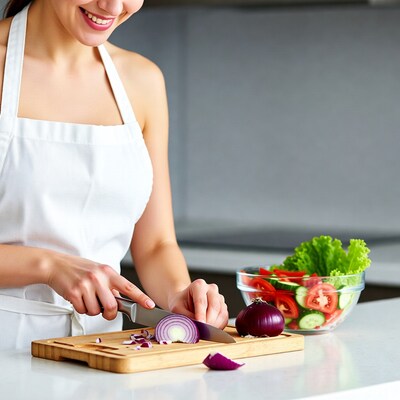 Woman chopping onion in kitchen