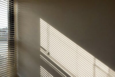 Sunlight Through White Blinds