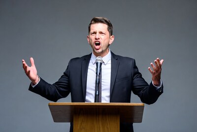 Man speaking passionately at podium