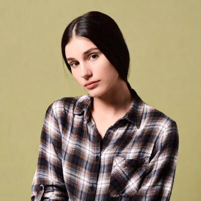 Woman in plaid shirt on green background