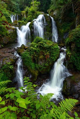Majestic multi-tiered waterfall in lush forest