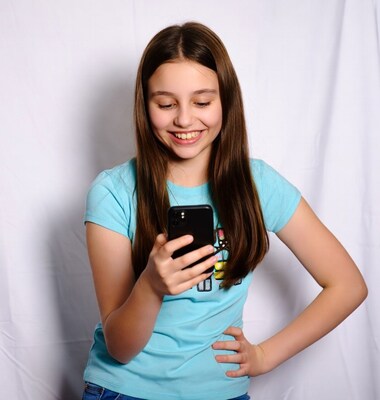 Teen girl smiling using smartphone