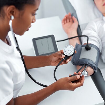 African-American nurse taking blood pressure