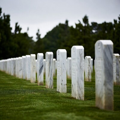 Row of White Headstones in Cemetery
