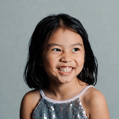 Asian girl smiling in sequin dress