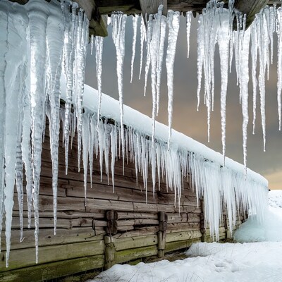 Icicles Hanging from Wooden Cabin Roof