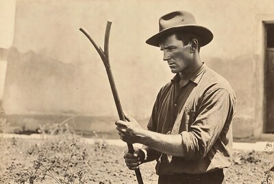 Man holding pitchfork in field