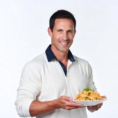 Man holding plate of pasta