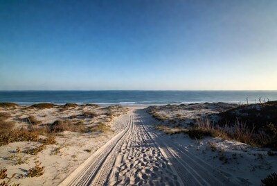 Sandy path to beach at sunset