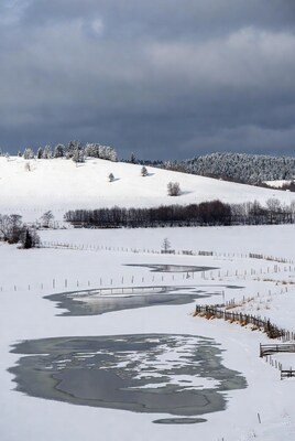 Snowy Landscape with Frozen Pond