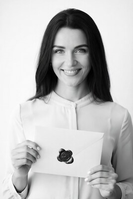 Woman holding sealed envelope