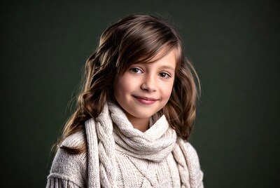 Girl smiling in white sweater and scarf