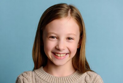 Smiling girl in beige sweater