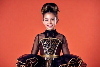 Girl in black gold dress smiling