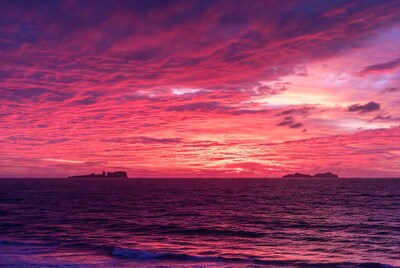 Vibrant Pink Sunset over Ocean Islands