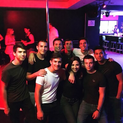 Group of friends posing at strip club