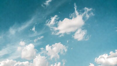 Fluffy white clouds in blue sky