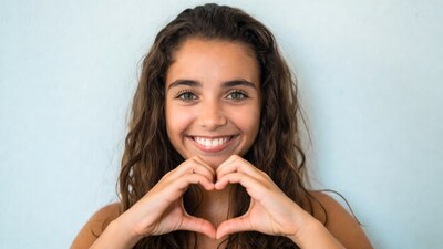 Smiling girl making heart hands