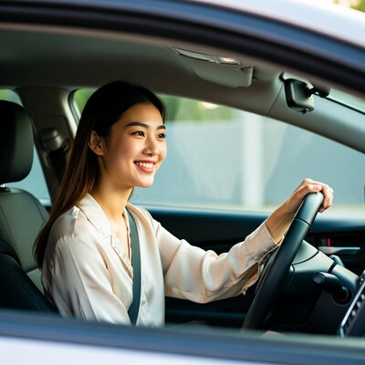 Asian woman driving car
