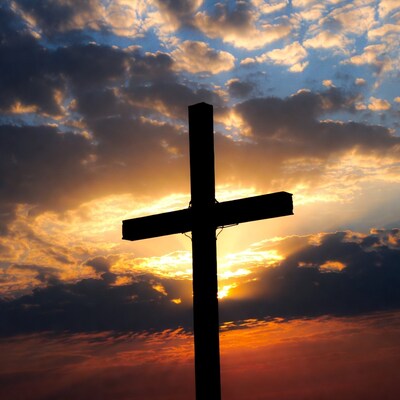 Silhouette cross at sunset