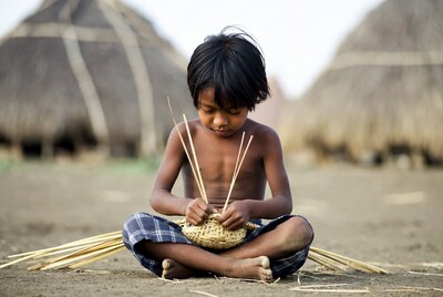 Young Asian boy weaving basket