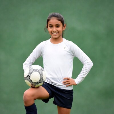 Girl holding soccer ball