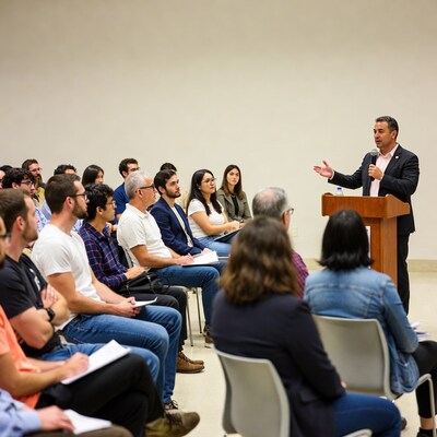 Man speaking at podium to audience