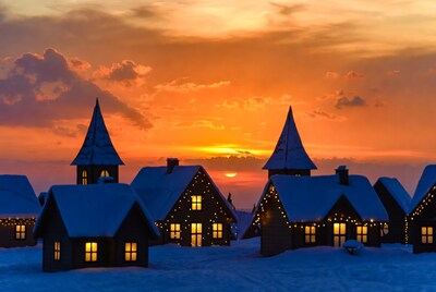 Snowy village houses at sunset