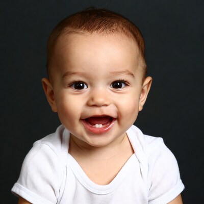 Smiling baby boy in white onesie