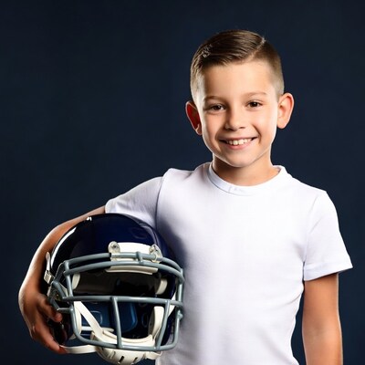 Boy holding football helmet