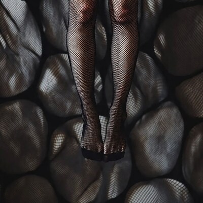 Woman's Legs in Black Fishnet Stockings