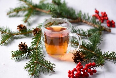 Hot Tea in Glass Mug with Christmas Branches